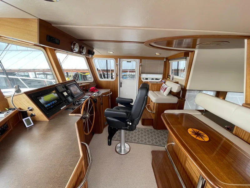 Slide: The Image of Interior of 2009 American Tug 49 Limited, featuring helm, seating, and navigation equipment. - 14