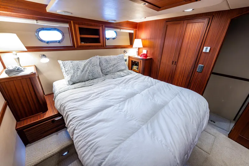 Slide: The Image of Luxurious cabin interior of 2009 American Tug 49 Limited with cozy bed and wooden furnishings. - 18
