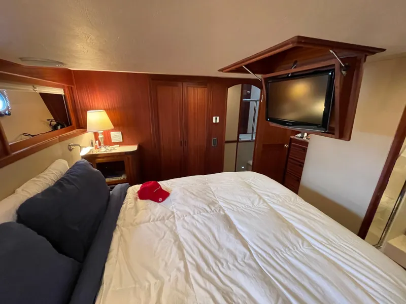 Slide: The Image of Cozy bedroom in 2009 American Tug 49 Limited with TV, lamp, and wooden accents. - 19