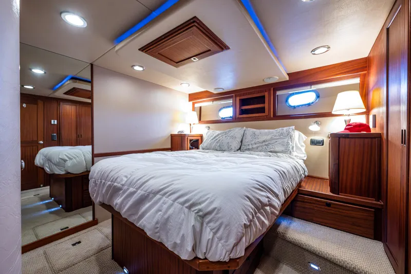 Slide: The Image of Luxurious cabin interior of 2009 American Tug 49 Limited with cozy bed and ambient lighting. - 20