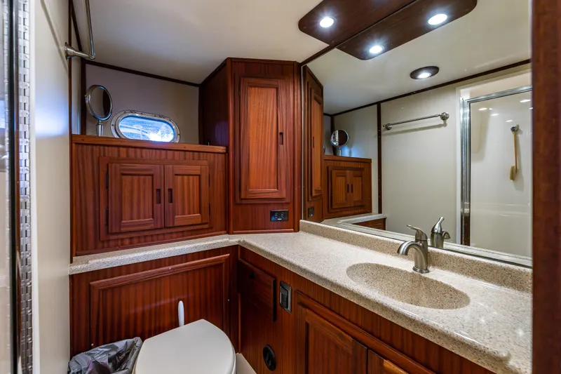 Slide: The Image of Luxurious bathroom in 2009 American Tug 49 Limited with wood cabinetry and modern fixtures. - 21