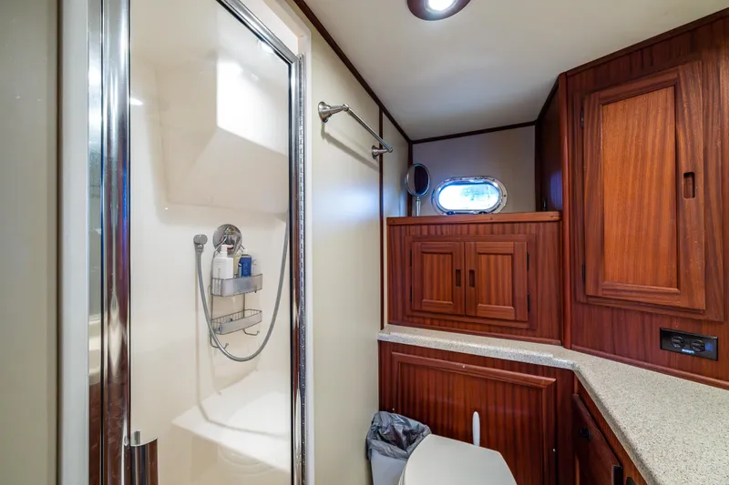 Slide: The Image of Bathroom interior of 2009 American Tug 49 Limited with wood cabinetry and shower. - 22