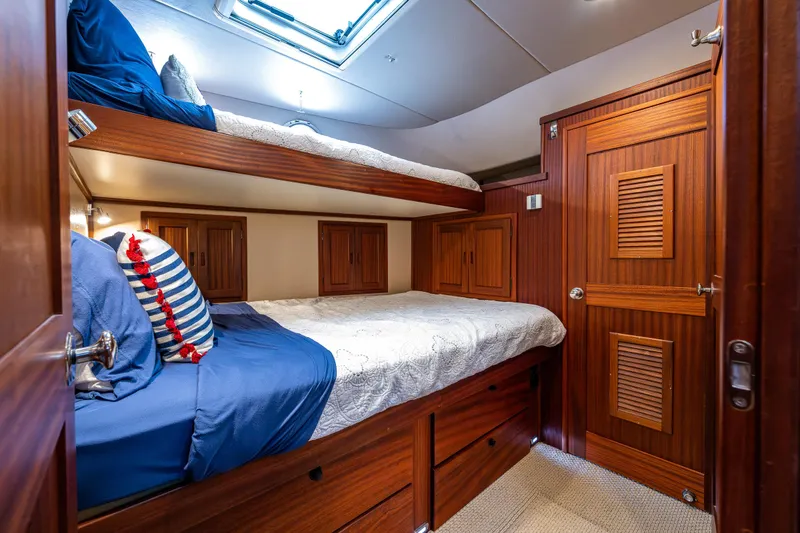 Slide: The Image of Cozy cabin with wooden bunk beds in a 2009 American Tug 49 Limited yacht. - 24
