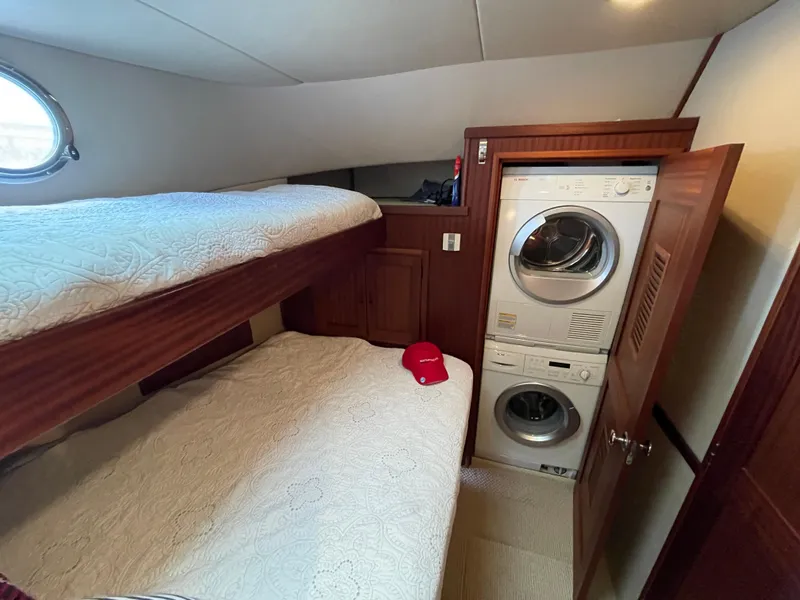 Slide: The Image of Cozy cabin with bunk beds and laundry in 2009 American Tug 49 Limited. - 25