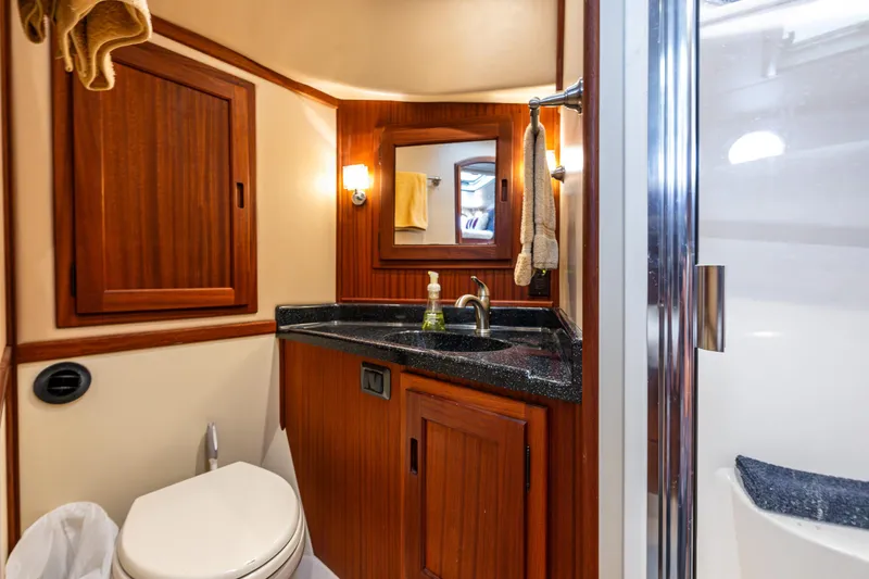 Slide: The Image of Luxurious bathroom in 2009 American Tug 49 Limited yacht with wood accents and modern fixtures. - 26