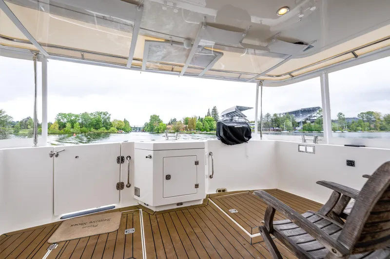 Slide: The Image of American Tug 49 Limited 2009 yacht deck with wooden flooring and scenic water view. - 30