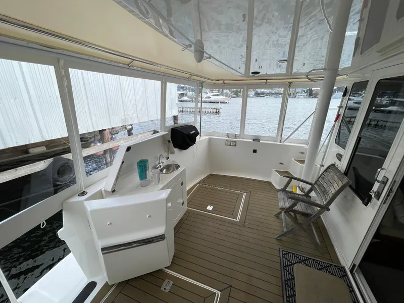 Slide: The Image of 2009 American Tug 49 Limited boat interior with seating and water views. - 32