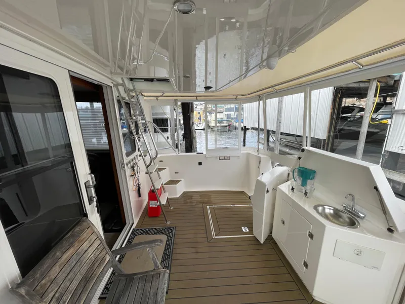 Slide: The Image of Spacious deck of 2009 American Tug 49 Limited with seating and sink. - 33