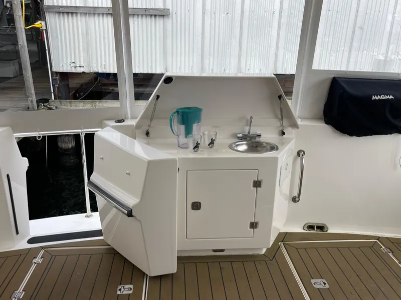 Slide: The Image of Outdoor kitchenette on 2009 American Tug 49 Limited yacht with sink and storage. - 34