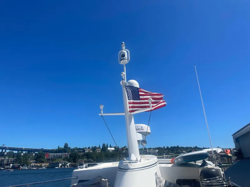 Slide: The Image of American Tug 49 Limited 2009 with U.S. flag on a sunny day by the water. - 38