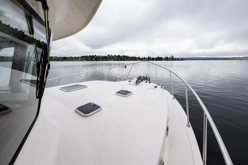Slide: The Image of 2009 American Tug 49 Limited on calm waters under cloudy skies. - 39