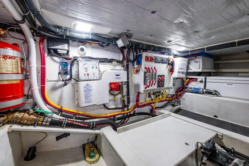 Slide: The Image of Engine room of 2009 American Tug 49 Limited, showcasing electrical systems and wiring. - 43