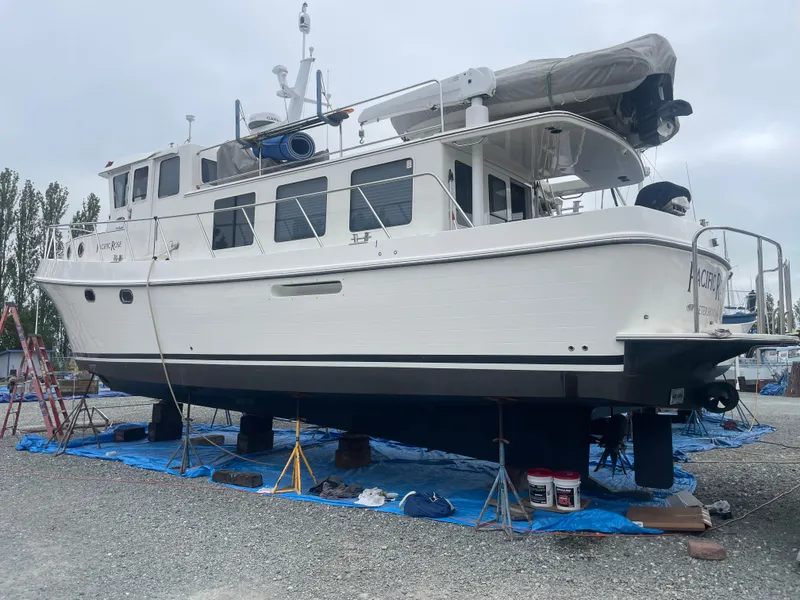 Slide: The Image of 2009 American Tug 49 Limited yacht on dry dock, undergoing maintenance. - 48