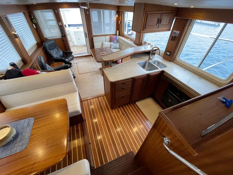 Slide: The Image of Luxurious interior of 2009 American Tug 49 Limited with wood finishes and spacious seating. - 9