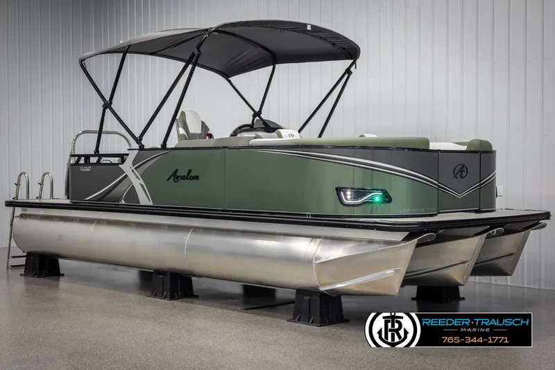 Slide: The Image of 2025 Avalon LSZ CRB pontoon boat with canopy, displayed indoors. - 3