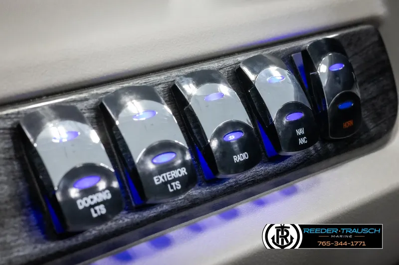 Slide: The Image of Control panel of 2025 Avalon LSZ CRB with illuminated switches for docking, exterior lights, and radio. - 36