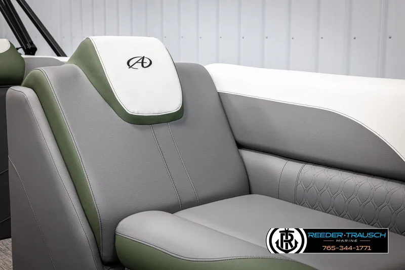 Slide: The Image of 2025 Avalon LSZ CRB boat seat with green and gray upholstery, featuring logo embroidery. - 38