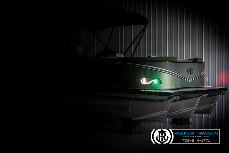 Slide: The Image of 2025 Avalon LSZ CRB boat with illuminated side light in a dimly lit setting. - 4