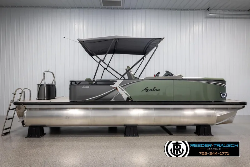 Slide: The Image of 2025 Avalon LSZ CRB pontoon boat with canopy in showroom, side view. - 5