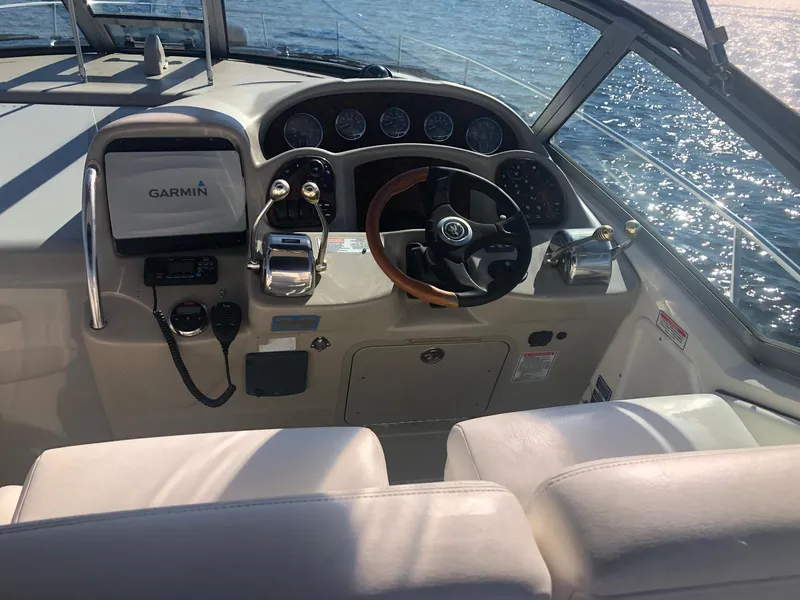Slide: The Image of Helm of 2006 Sea Ray 320 Sundancer with Garmin navigation, steering wheel, and controls. - 12