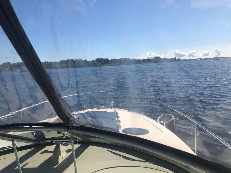 Slide: The Image of 2006 Sea Ray 320 Sundancer cruising on a sunny day, view from the helm. - 14