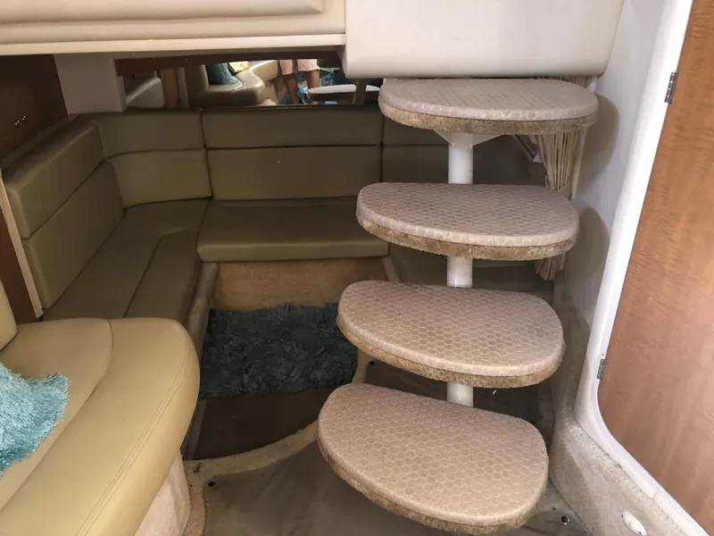 Slide: The Image of Interior of 2006 Sea Ray 320 Sundancer with curved steps and beige seating area. - 20