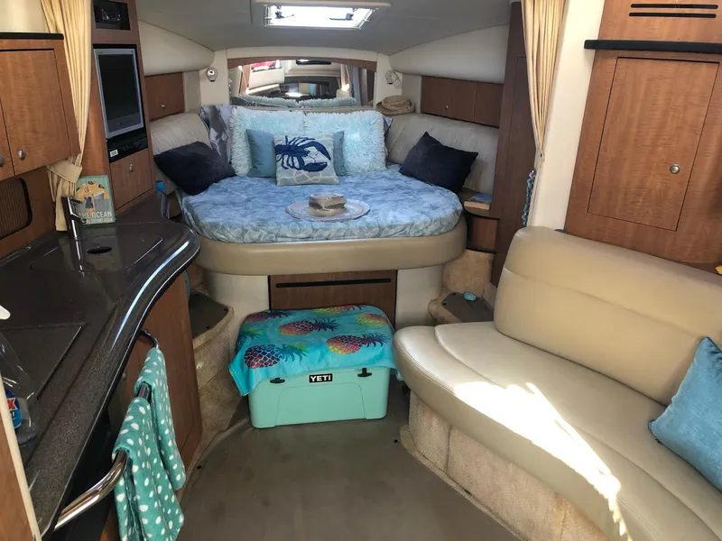 Slide: The Image of Interior of 2006 Sea Ray 320 Sundancer with cozy seating and bed. - 21