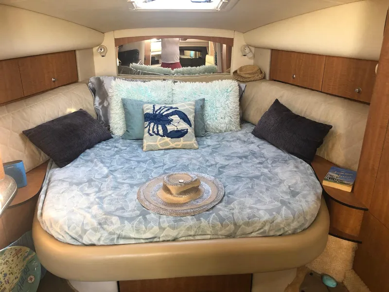 Slide: The Image of Cozy cabin interior of 2006 Sea Ray 320 Sundancer with plush bedding and decorative pillows. - 24