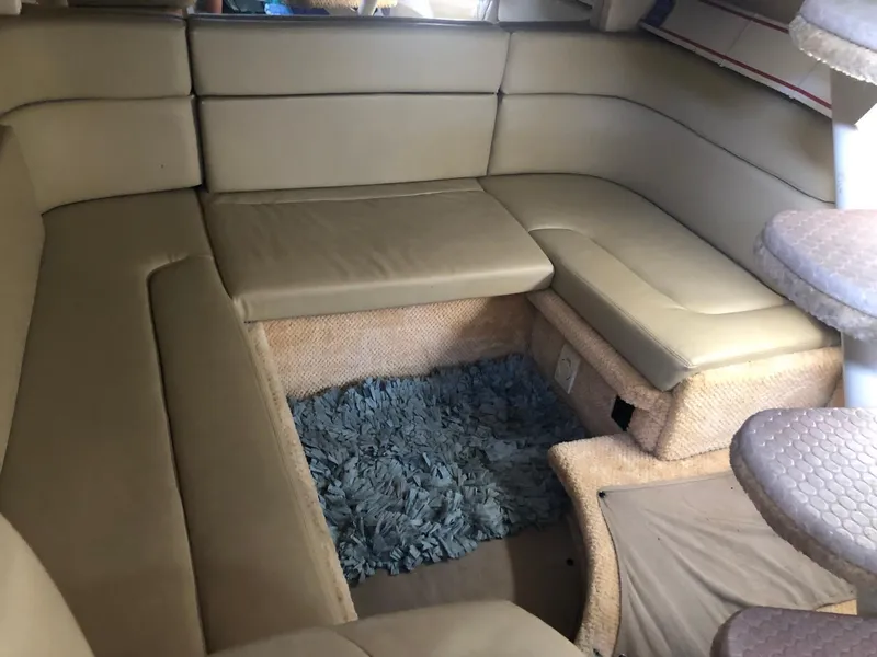 Slide: The Image of Interior of 2006 Sea Ray 320 Sundancer with beige seating and blue rug. - 27