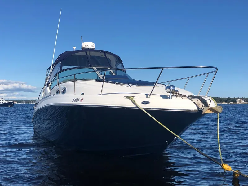 Slide: The Image of 2006 Sea Ray 320 Sundancer boat anchored on calm water under clear blue sky. - 4