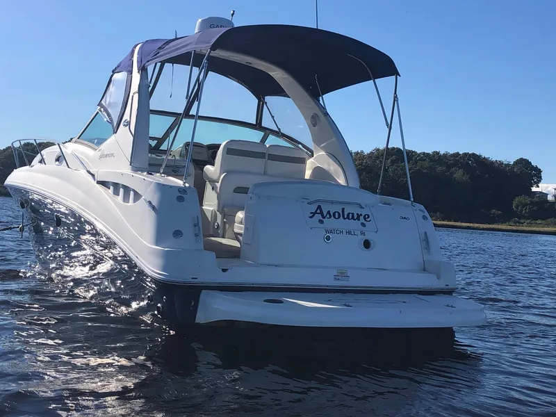 Slide: The Image of 2006 Sea Ray 320 Sundancer boat on calm water, rear view with canopy. - 6