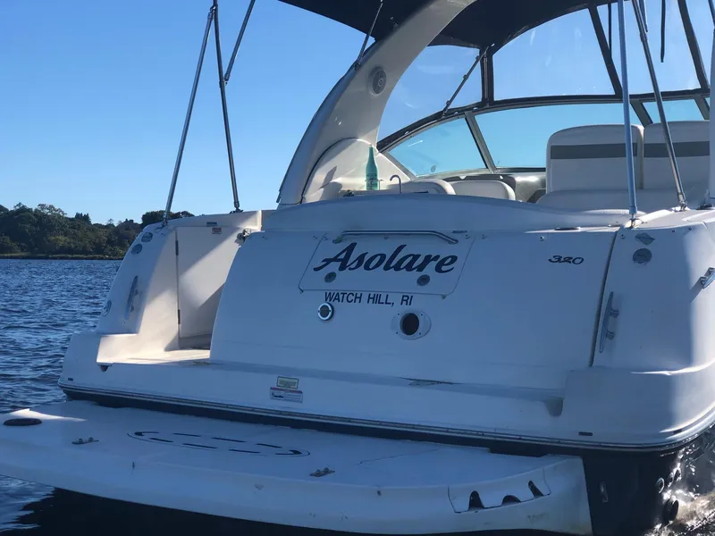 Slide: The Image of 2006 Sea Ray 320 Sundancer boat on water, rear view, with "Asolare" name. - 7
