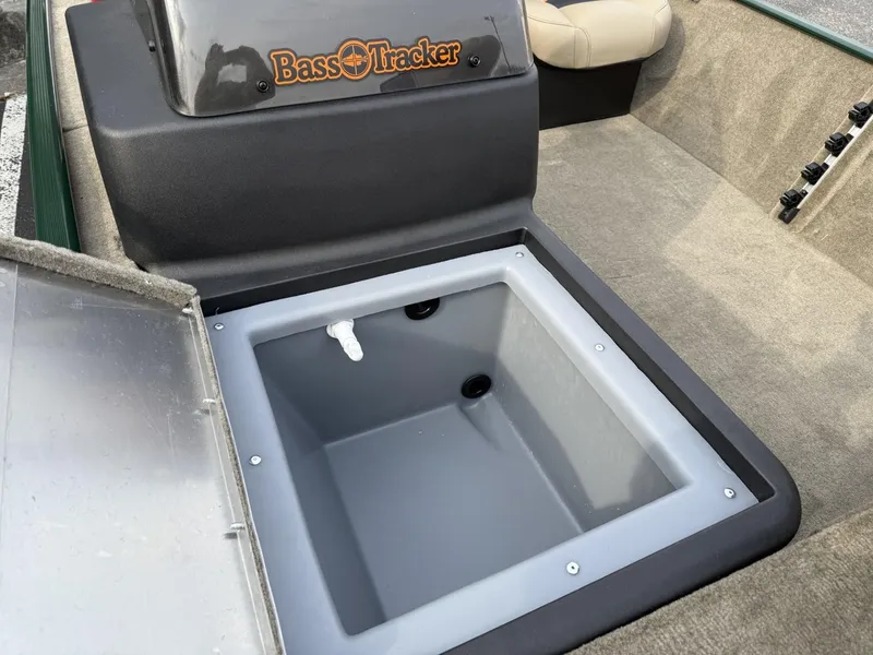 Slide: The Image of 2025 Tracker Bass Tracker Classic Limited boat with open storage compartment. - 11