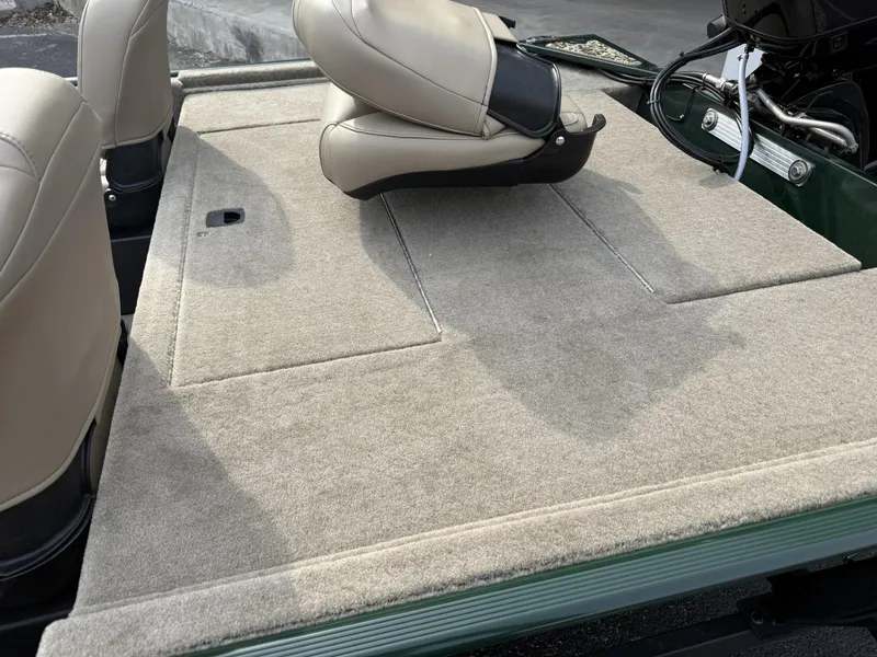 Slide: The Image of 2025 Tracker Bass Tracker Classic Limited boat interior with beige seating and carpeted deck. - 4