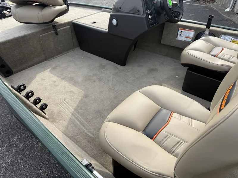 Slide: The Image of 2025 Tracker Bass Tracker Classic Limited boat interior with beige seats and steering console. - 5