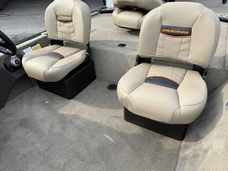 Slide: The Image of 2025 Tracker Bass Tracker Classic Limited boat seats, beige upholstery, interior view. - 6