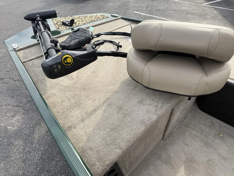 Slide: The Image of 2025 Tracker Bass Tracker Classic Limited boat with beige seating and trolling motor. - 7