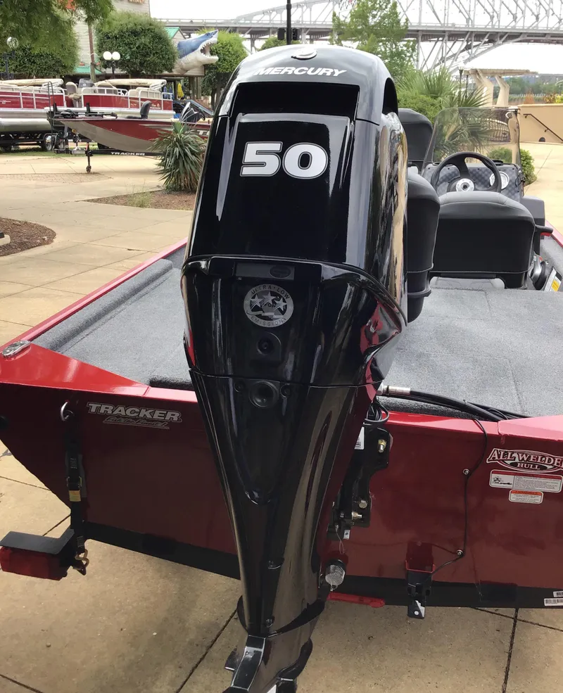 Slide: The Image of 2025 Tracker Bass Tracker Classic XL with Mercury 50 outboard motor, parked outdoors. - 3
