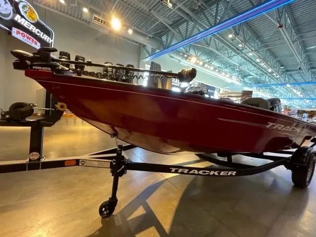 Slide: The Image of 2025 Tracker Super Guide V-16 SC boat on display in showroom. - 2