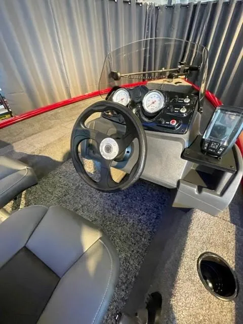 Slide: The Image of 2025 Tracker Super Guide V-16 SC boat dashboard with steering wheel and gauges. - 4
