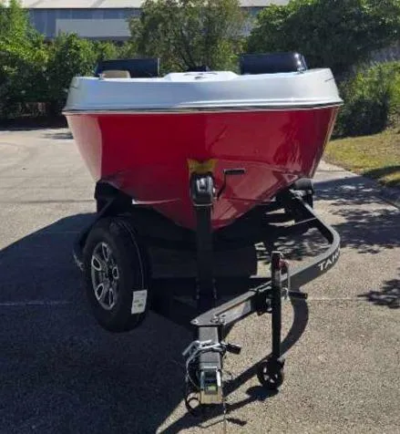 Slide: The Image of 2025 Tahoe T21 boat on trailer, red hull, parked outdoors. - 4