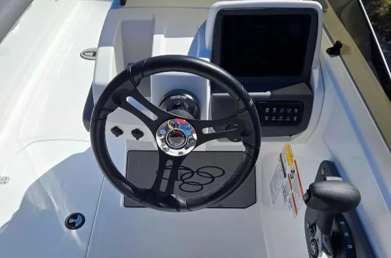 Slide: The Image of Steering console of 2025 Tahoe T21 boat with modern controls and display. - 5