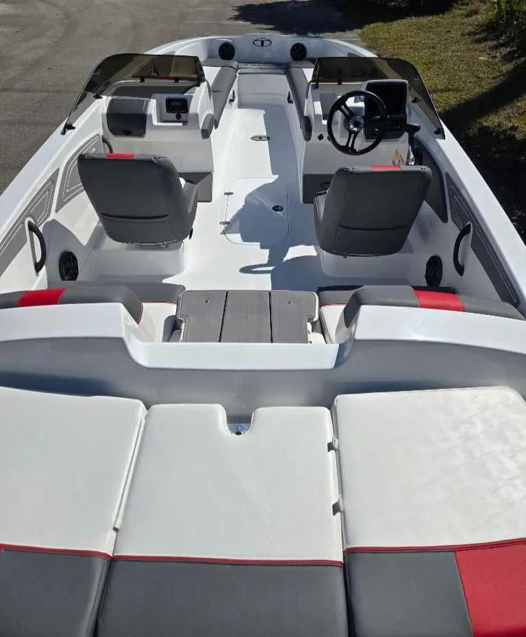 Slide: The Image of 2025 Tahoe T21 boat interior with modern seating and steering console. - 7