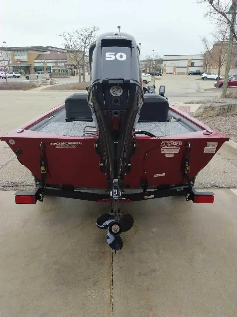 Slide: The Image of 2025 Tracker Pro 170 boat with 50 HP engine, rear view in a parking lot. - 4