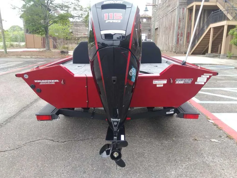 Slide: The Image of 2025 Tracker Pro Team 190 boat with 115 HP engine, parked outdoors. - 2