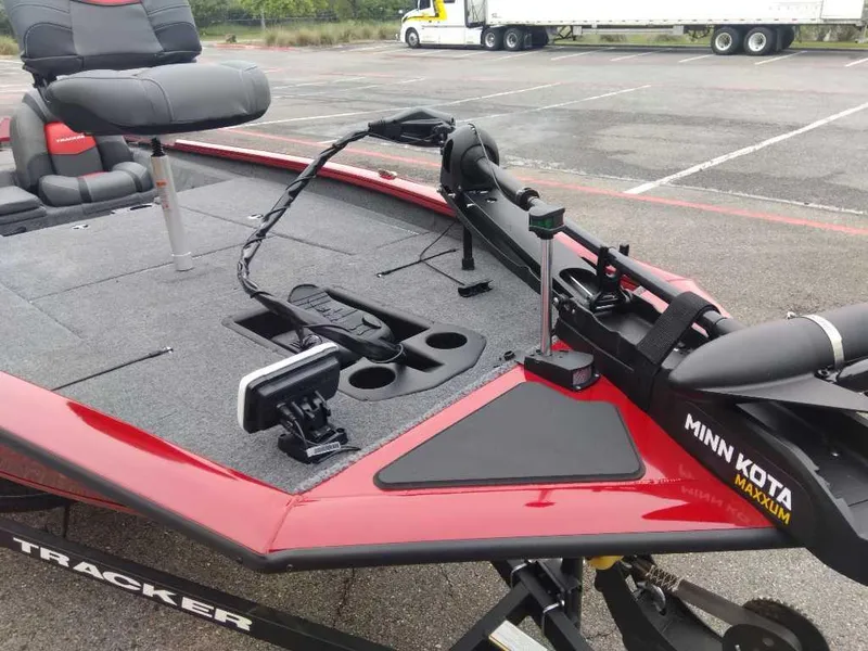 Slide: The Image of 2025 Tracker Pro Team 190 boat with Minn Kota trolling motor in a parking lot. - 7