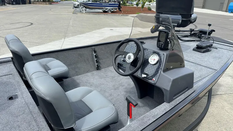 Slide: The Image of 2025 Tracker Bass Tracker Classic XL boat in showroom, featuring a Minn Kota trolling motor. - 13