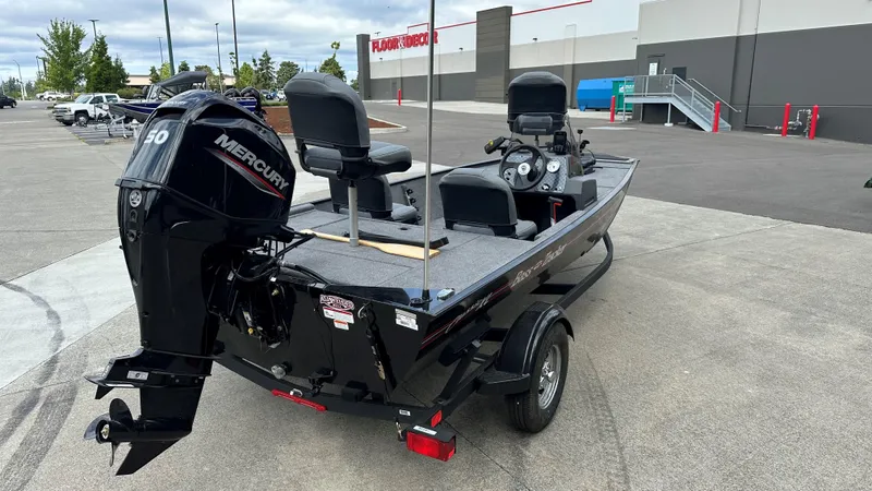 Slide: The Image of 2025 Tracker Bass Tracker Classic XL boat interior with steering wheel and Lowrance electronics. - 14