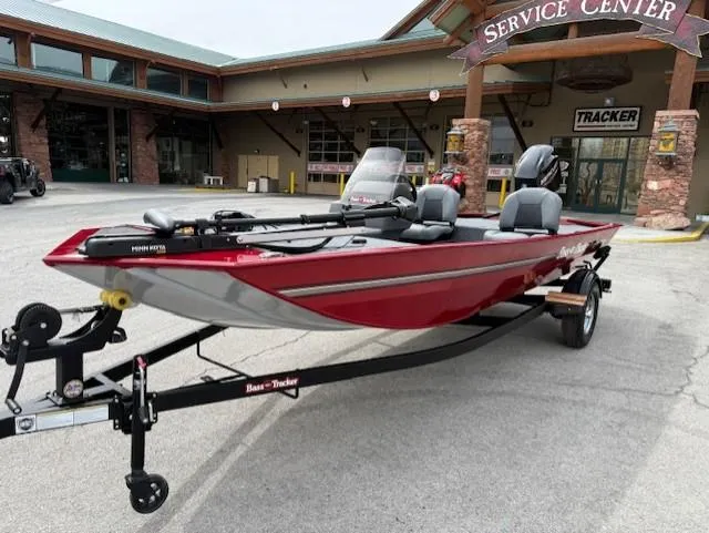 Slide: The Image of 2025 Tracker Bass Tracker Classic XL boat at service center, red exterior, on trailer. - 2