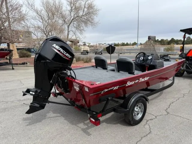 Slide: The Image of 2025 Tracker Bass Tracker Classic XL boat with Mercury engine, parked outdoors. - 3